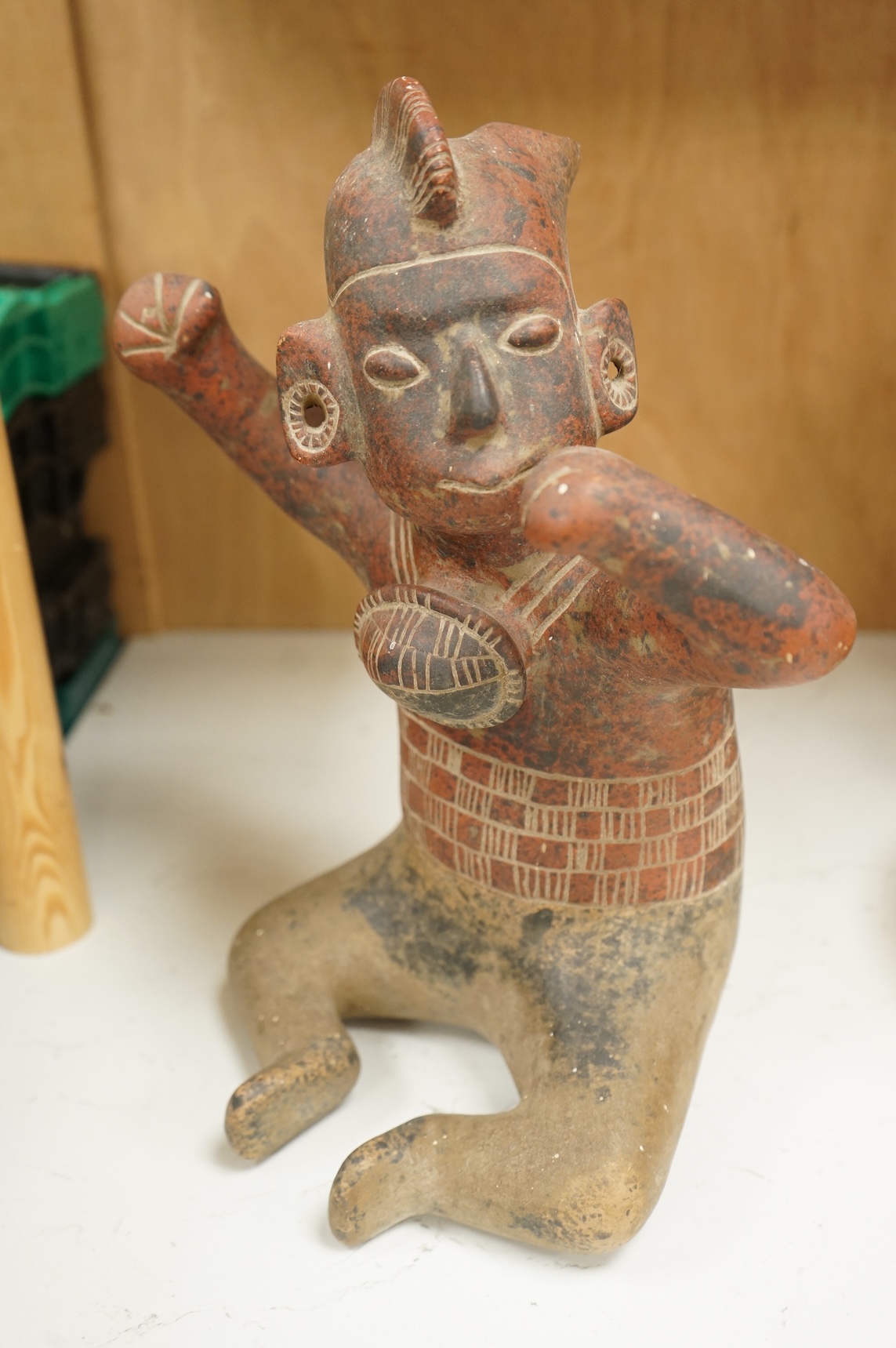 A terracotta pre-Columbian style warrior, over 60 years old, 34cm high
